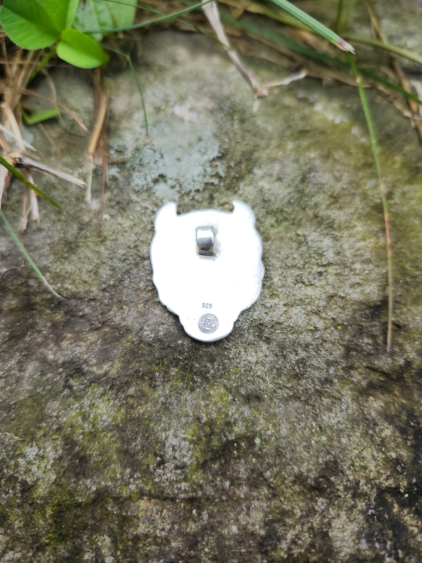 Back side of the one-of-a-kind sterling silver Oni mask pendant.