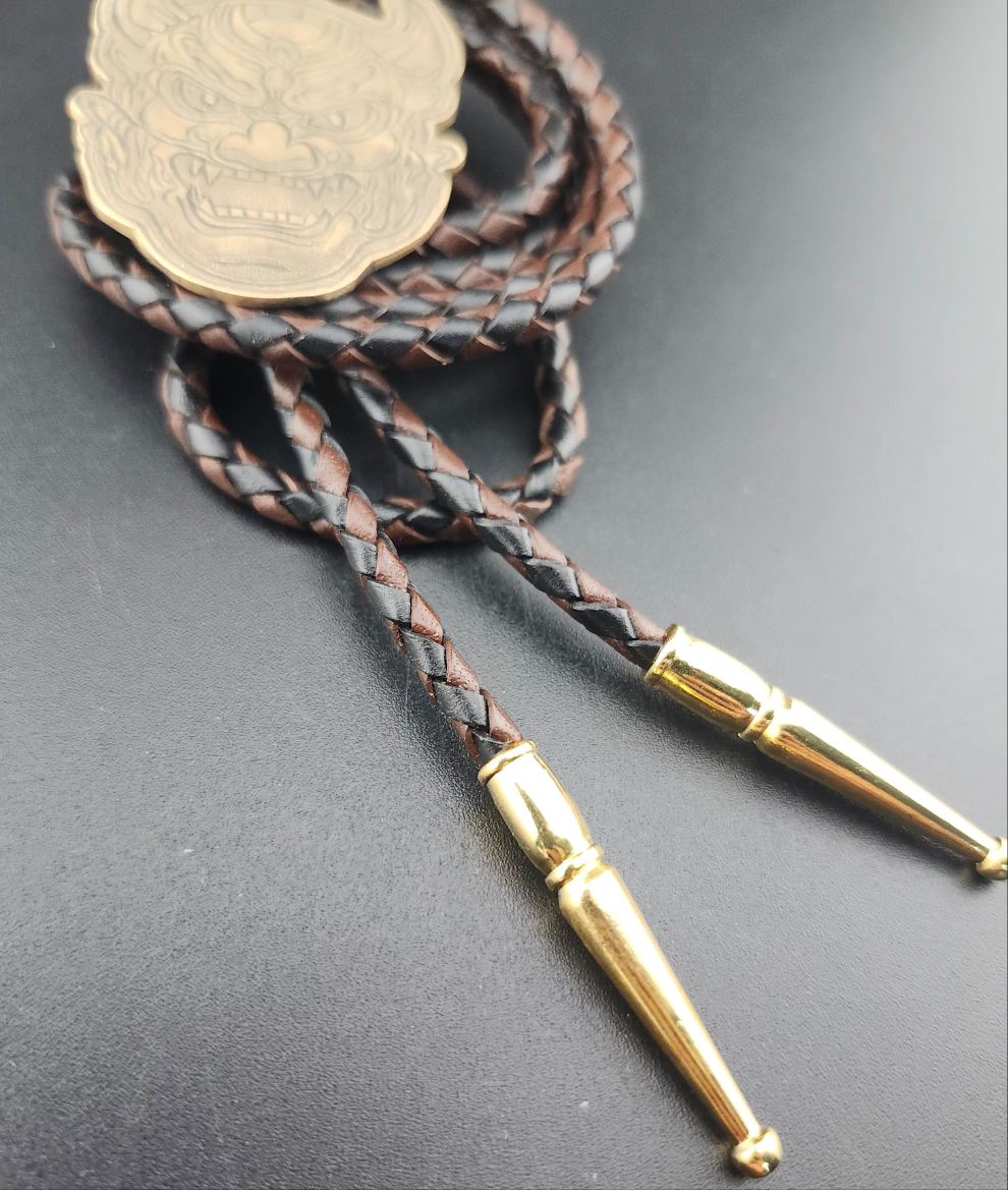 Oni Mask Bolo Tie – Hand-Engraved Brass on Braided Leather