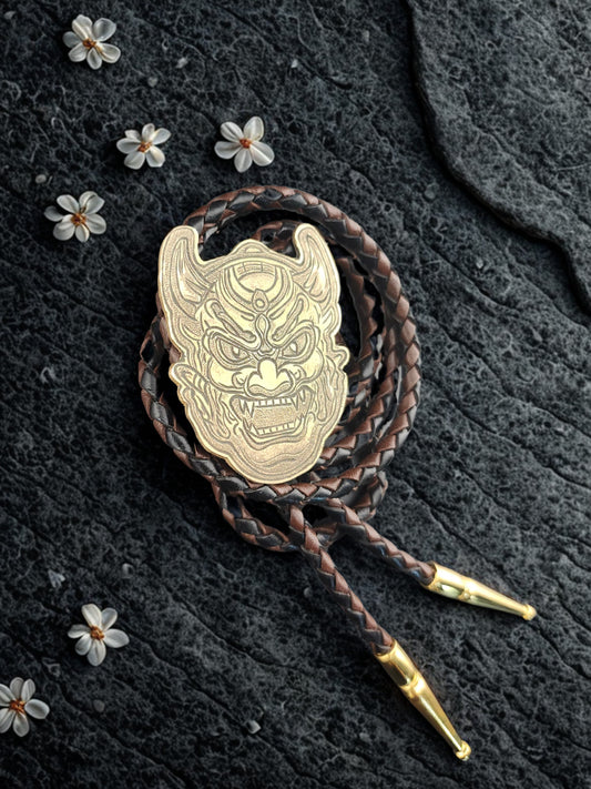 Oni Mask Bolo Tie – Hand-Engraved Brass on Braided Leather