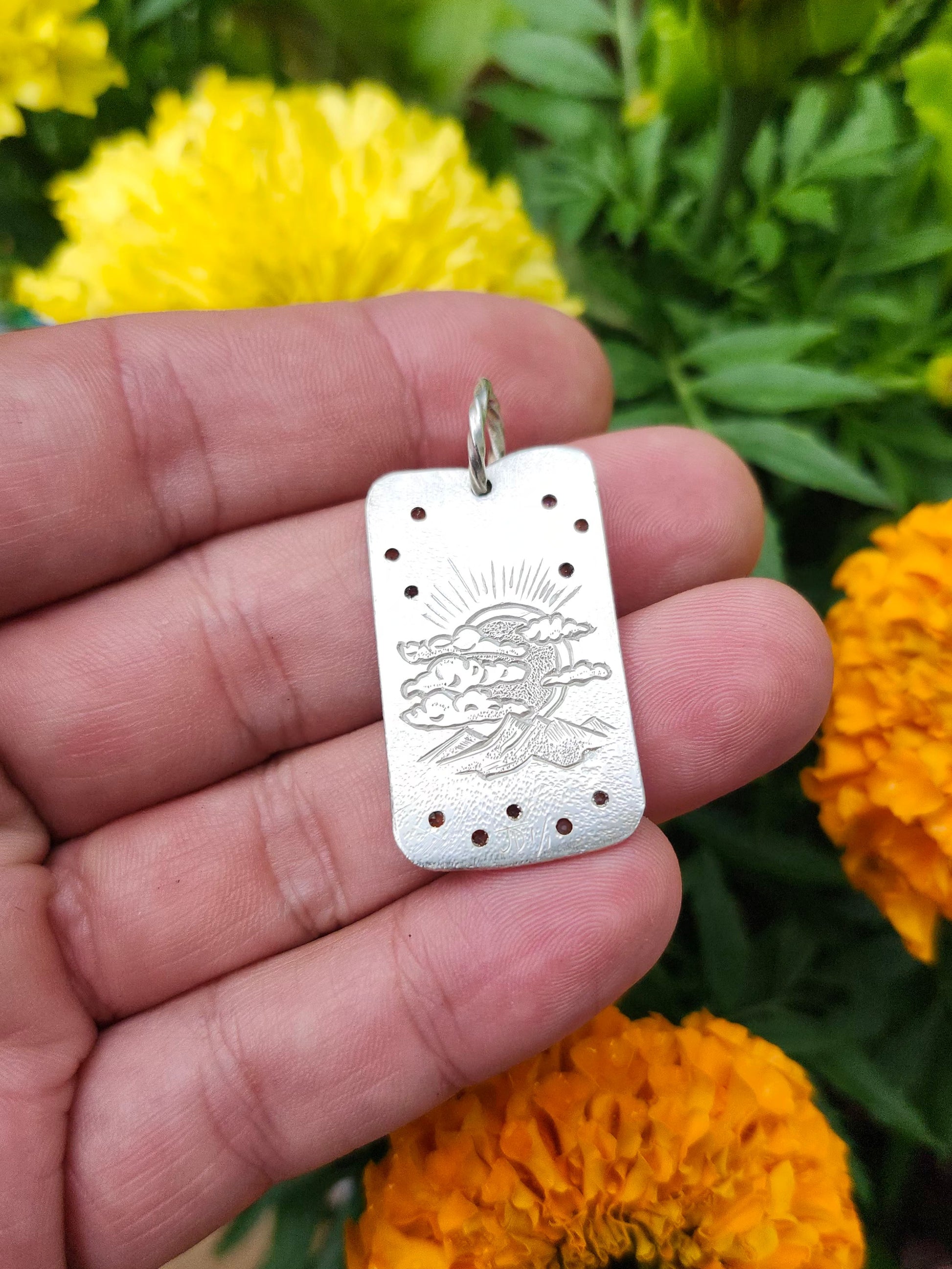 Back of engraved dog tag pendant featuring sun and mountain design